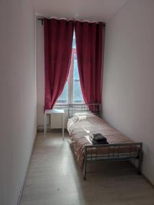 a bedroom with a bed and a window with red curtains at Room in Guest room - Chambre A Bruxelles a in Brussels