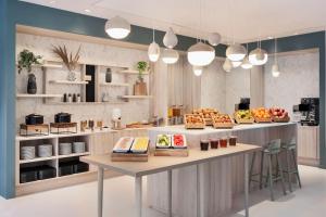 a kitchen with a counter with food on it at Fairfield by Marriott Copenhagen Nordhavn in Copenhagen