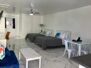 a living room with two beds and a table at Stay BnB in Nassau