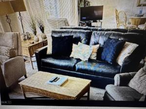 a living room with a blue couch and a coffee table at Nani Kai Hale in Kihei