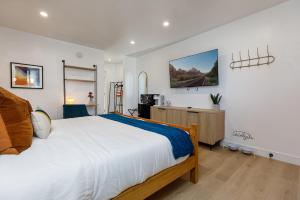 a bedroom with a large bed and a dresser at Quail Park Lodge in Kanab