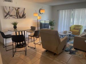 a living room with a couch and a table and chairs at Your Cozy Place in West Palm Beach
