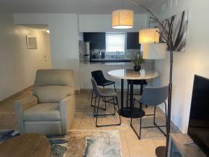a living room with a couch and a table and chairs at Your Cozy Place in West Palm Beach +19 photos