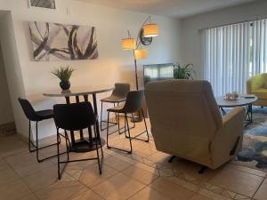 a living room with a table and chairs at Your Cozy Place in West Palm Beach
