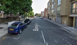 an empty street with cars parked on the side of the road at Bethnal Green/Brick Lane 2 Bedroom Apartment in London