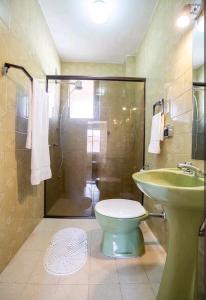uma casa de banho com um chuveiro, um WC e um lavatório. em Quarto Cidade Nova BH em Belo Horizonte