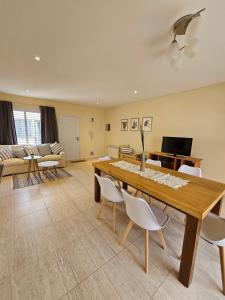 a living room with a wooden table and chairs at Azcuenaga Sur 2 in Guaymallen