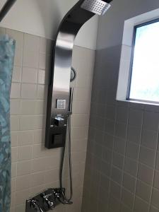 a shower with a shower head in a bathroom at Apartment close to Tech Giants, fast internet in East Palo Alto