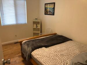 a bedroom with a bed and a window at Apartment close to Tech Giants, fast internet in East Palo Alto