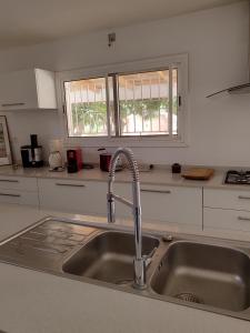 a kitchen counter with a sink and a window at HaciendO in Somone