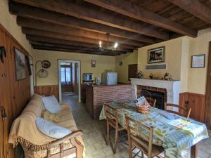 a living room with a couch and a table at Gîte champêtre avec jardin clos, près du lac d'Eguzon et Gargilesse-Dampierre ! - FR-1-591-127 in Orsennes