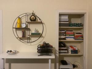 a room with a desk and a shelf with books at Renton Residence in Renton