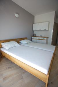 a bedroom with a large bed with white sheets at Planeta in Ustronie Morskie