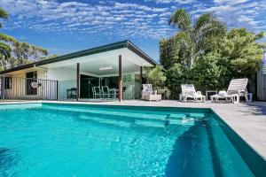 a swimming pool in front of a house at Beach & Boats Agnes Water in Agnes Water