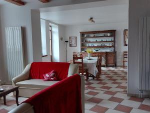 a living room with a couch and a table at Charmant gîte historique avec terrasse, salle de jeux, et recharge électrique – proche Vittel & Contrexéville - FR-1-589-219 in Serocourt