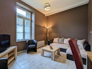 un salon avec un canapé et une télévision dans l'établissement Gîte confortable 3 chambres au bord de l'Allier - FR-1-582-16, à Saint-Julien-des-Chazes