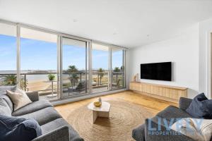 a living room with a view of the ocean at Beach Street Luxury 3 Bed with Beach & Bay Views in Melbourne