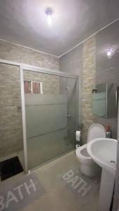 a bathroom with a shower and a toilet and a sink at La Castillada House in Santa Cruz de Barahona