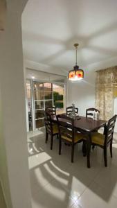 a dining room with a wooden table and chairs at La Castillada House in Santa Cruz de Barahona