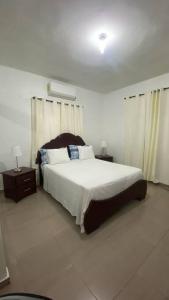 a bedroom with a large bed and two night stands at La Castillada House in Santa Cruz de Barahona
