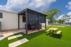 a house with a table and a bench in a yard at Bella’s BnB in Comfort