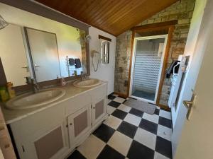 łazienka z 2 umywalkami i podłogą wyłożoną szachownicą w obiekcie Maison climatisée, 2 gîtes, 2 chambres, 15 hectares, loisirs, animaux acceptés - FR-1-426-520 w mieście Bouin +11 zdjęć