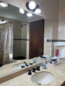 a bathroom with a sink and a large mirror at CASA GRAND BOURG CON MAGNÍFICA VISTA Y PILETA in Salta