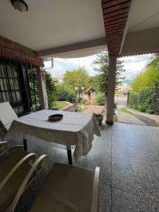 a table and chairs on a patio with a view of a yard at CASA GRAND BOURG CON MAGNÍFICA VISTA Y PILETA in Salta +21 photos