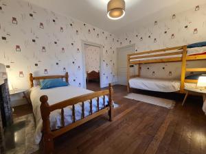 1 Schlafzimmer mit 2 Betten und einer mit Fotos bedeckten Wand in der Unterkunft Gîte Saint-Marcel, 4 pièces, 7 personnes - FR-1-591-444 in Saint-Marcel