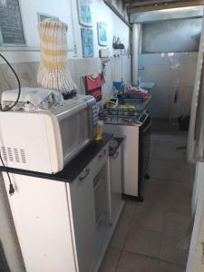 a kitchen with a microwave and a stove at Pousada Suítes Meireles in Fortaleza +26 photos
