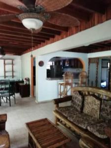 a living room with a couch and a ceiling fan at Mountain Chalet in Los Altos de Cerro Azul