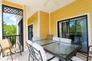 a dining room with a table and chairs on a balcony at Our Happy Place in Kissimmee