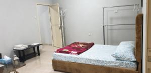 a bedroom with a bed and a table in a room at HOUSE IN AL AIN - 3 in Al Ain