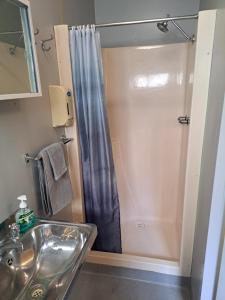 a bathroom with a shower and a sink at Cooktown Fishing Haven in Cooktown