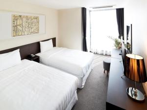 Postel nebo postele na pokoji v ubytování Hotel K-Tree Pyeongtaek