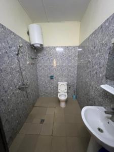 a bathroom with a toilet and a sink at RESIDENCE OUAGA in Ouagadougou