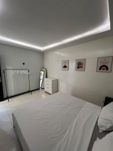 a bedroom with a large white bed in a room at Le cocon by sdm in Dakar