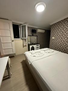 a bedroom with a large white bed in a room at Sophia Studio Apart Hotel in Istanbul