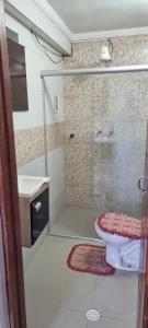 a bathroom with a shower with a toilet and a sink at Casa com piscina e lazer em SBC SP in São Bernardo do Campo
