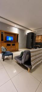 a living room with a couch and a flat screen tv at Casa en alquiler temporario Formosa in Formosa