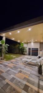 a room with a bed and a patio at night at Casa en alquiler temporario Formosa in Formosa