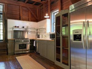 a kitchen with stainless steel appliances and wooden ceilings at Meadows Mill House III in Salem +19 photos