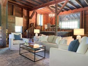a living room with white couches and a table at Meadows Mill House III in Salem