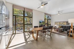 a kitchen and dining room with a table and chairs at Ecocrackenback Chalet 18 in Crackenback