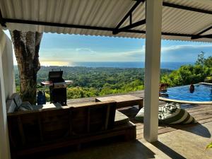 a view from the porch of a house with a swimming pool at Padawatu Villas in Uluwatu