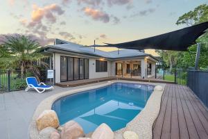 a swimming pool in front of a house at Luxury Style Living 20 minutes from CBD 