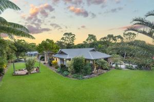 a house with a large yard with green grass at Luxury Style Living 20 minutes from CBD 