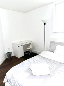 a white bedroom with a desk and a bed at Private bedroom 1 block from Downtown Miami in Miami
