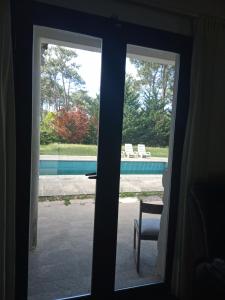 una puerta corredera de cristal con vistas a la piscina en Chiquense, en Punta del Este