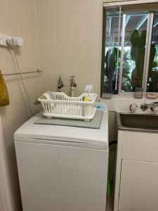 a small kitchen with a refrigerator and a sink at The singing frogs studio in Coffs Harbour +27 photos